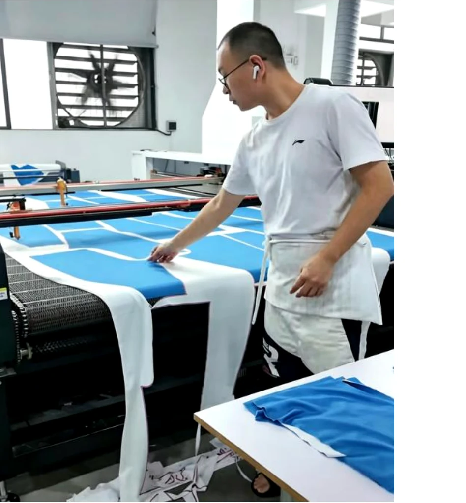 Operator reviewing printed apparel material