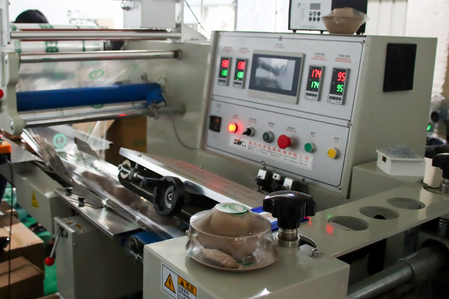 Operator checking eco utensil production line inside supplier facility