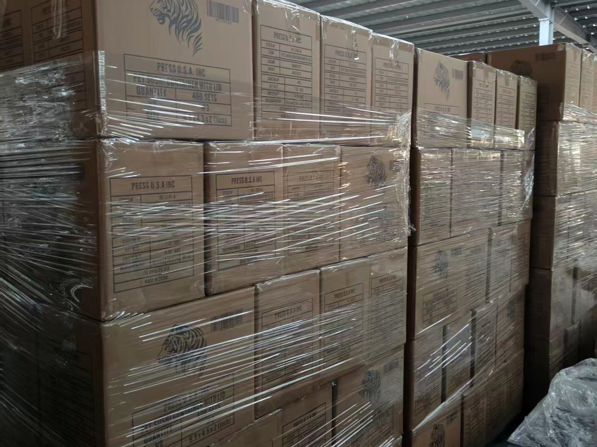 Wrapped cartons prepared on pallets inside a warehouse